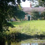 The main Farmhouse B&B from the Lake | Glan Clwyd Isa